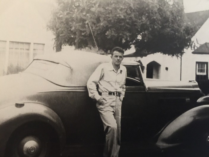 Man standing in front of car in 1935