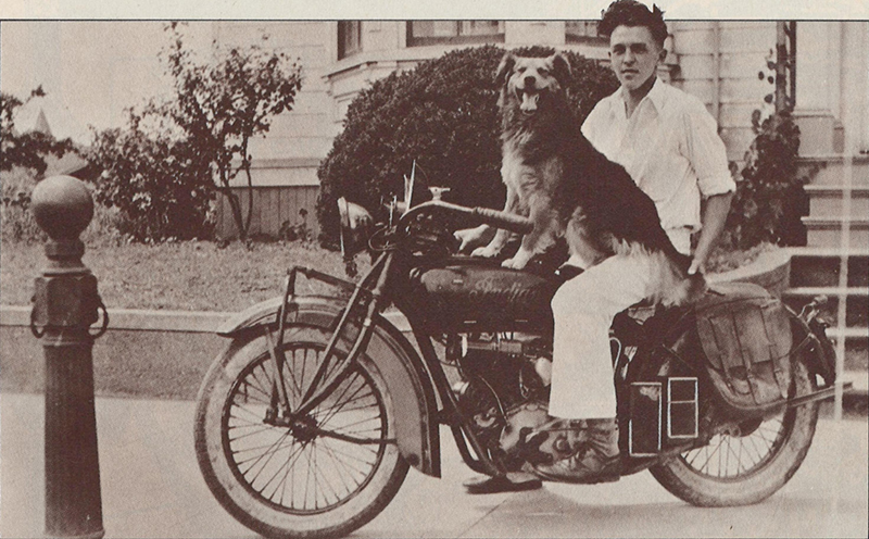 Man on Indian Scout with dog in lap