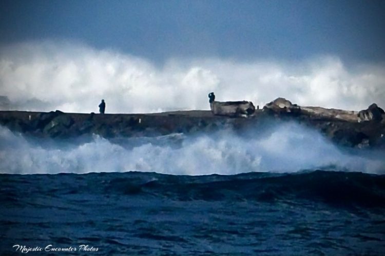 Wave watchers at risk on the north jetty (Photo by Rick Urban)